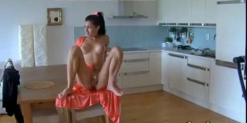 hot girl fingers her pussy in her kitchen