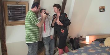 Mature woman takes two cocks on camera