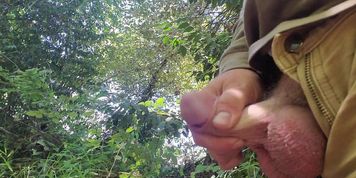 Stroking half hard dick while pissing 