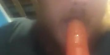 Fat guy sucking on dildo