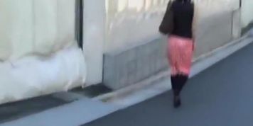 Japanese sharking video showing a chick in a red skirt