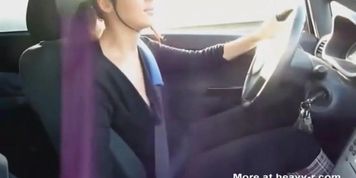 Nice looking woman gives handjob while driving