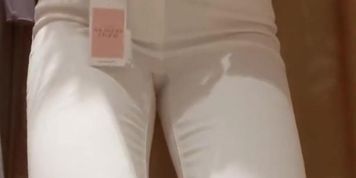 Naughty girl in fitting room dances striptise and takes off her bra