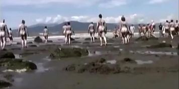 Naked performance art on the beach