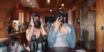 Cute blonde girl in full face gas mask talking