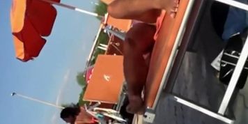 Milf lying by the pool and touching pussy