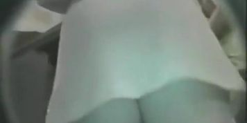 Upskirt video of a woman in white things on the nighttime streets