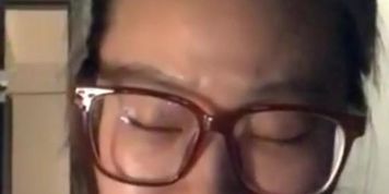 Chinese cutie wearing glasses andsmoking a slim vogue and is bored by her side boy