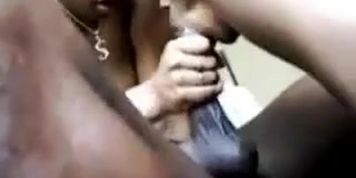 Two black ladies blowing a guy