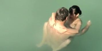 Spying two teenagers fuck in the water