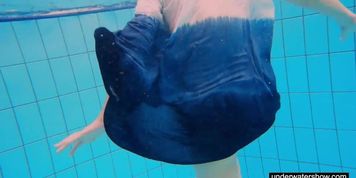 Teen girl Avenna is swimming in the pool