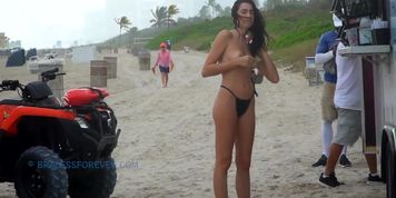 Buying a snack at the beach topless
