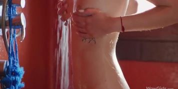 Lovely chick with small tits is taking a hot shower