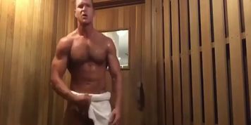 Muscle jock shoots load in public sauna