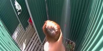 Mature lady caught in a beach shower