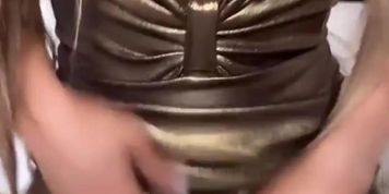 Latina dances in a golden dress