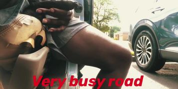 Uber driver flashing by busy road