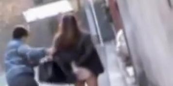 Naughty man sharking Asian college girl skirt in the street