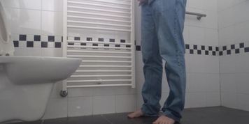 Desperate pee in bathroom, wetting pants and floor. End with cumshot