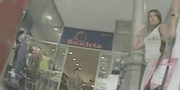 Woman in white skirt gets filmed by a nasty voyeur in the shop