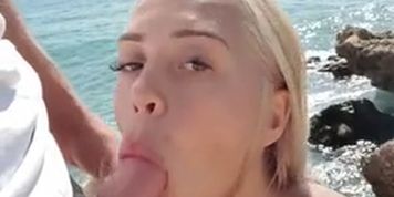 Cute blonde sucks my cock on the public beach