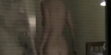 Girl is naked exposing hot firm tits on window voyeur cam