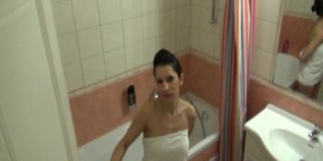 Showering brunette girl plays with her snatch