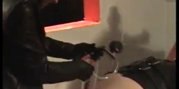 Sexy mistress uses penis pump on a latex wearing slave