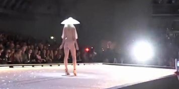 Seductive fashion model in a weird hat walks down the catwalk in the nude (Sarah Lollypop)