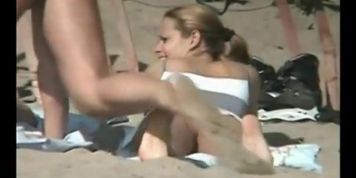 Tempting women sunbathing in a nude beach video