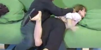 spanked on a green sofa
