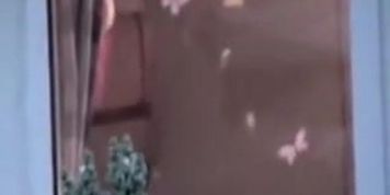 Neighbor is undressing on the window voyeur video