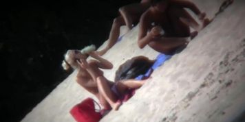 Nude beach blonde model being filmed by a voyeur