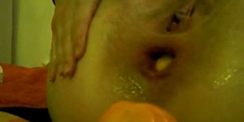 Extreme anal masturbation with orange