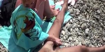 Wife strokes mans penis in beach