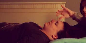 Amazing hands with long pink nails, performing some kind of healing therapy