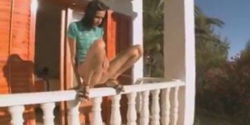 Russian brunette peeing off the porch