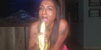 Topless desi squeezes her tits as she sucks and deepthroats on a banana