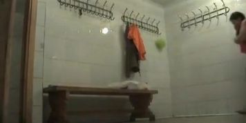 A plump girl  wipes herself in the school swimming pool dressing room
