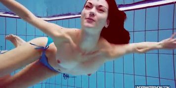 Redhead in blue bikini showing her body