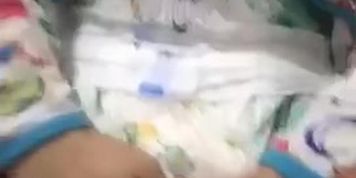 Diaper boy playing in wet diaper 