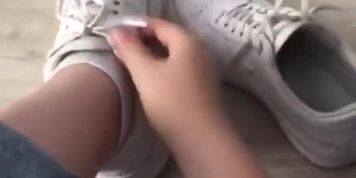 a girl shows me her sneakers and socks