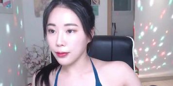 Beautiful Asian camgirl in swimsuit shows her body