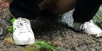 Pissing outside on a rock
