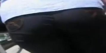 A hefty xxxl woman in a street candid video walks in tight black jeans