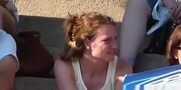 Look under the skirt of a woman who is sitting on the steps