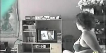 Sweet milf in bra watching TV and masturbating hotly