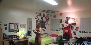 College girls playing dress up in dorm room