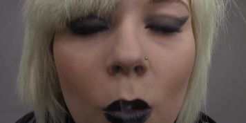 Beautiful young blond smoking in black lipstick