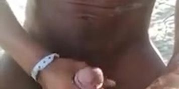Black guy cums on MILF's feet on the beach